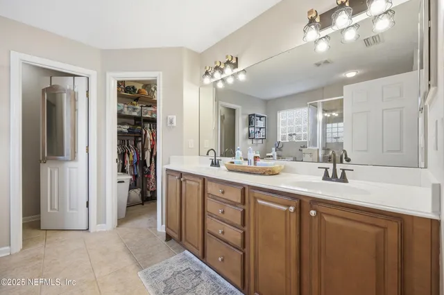 a spacious bathroom with a double vanity sink and a mirror