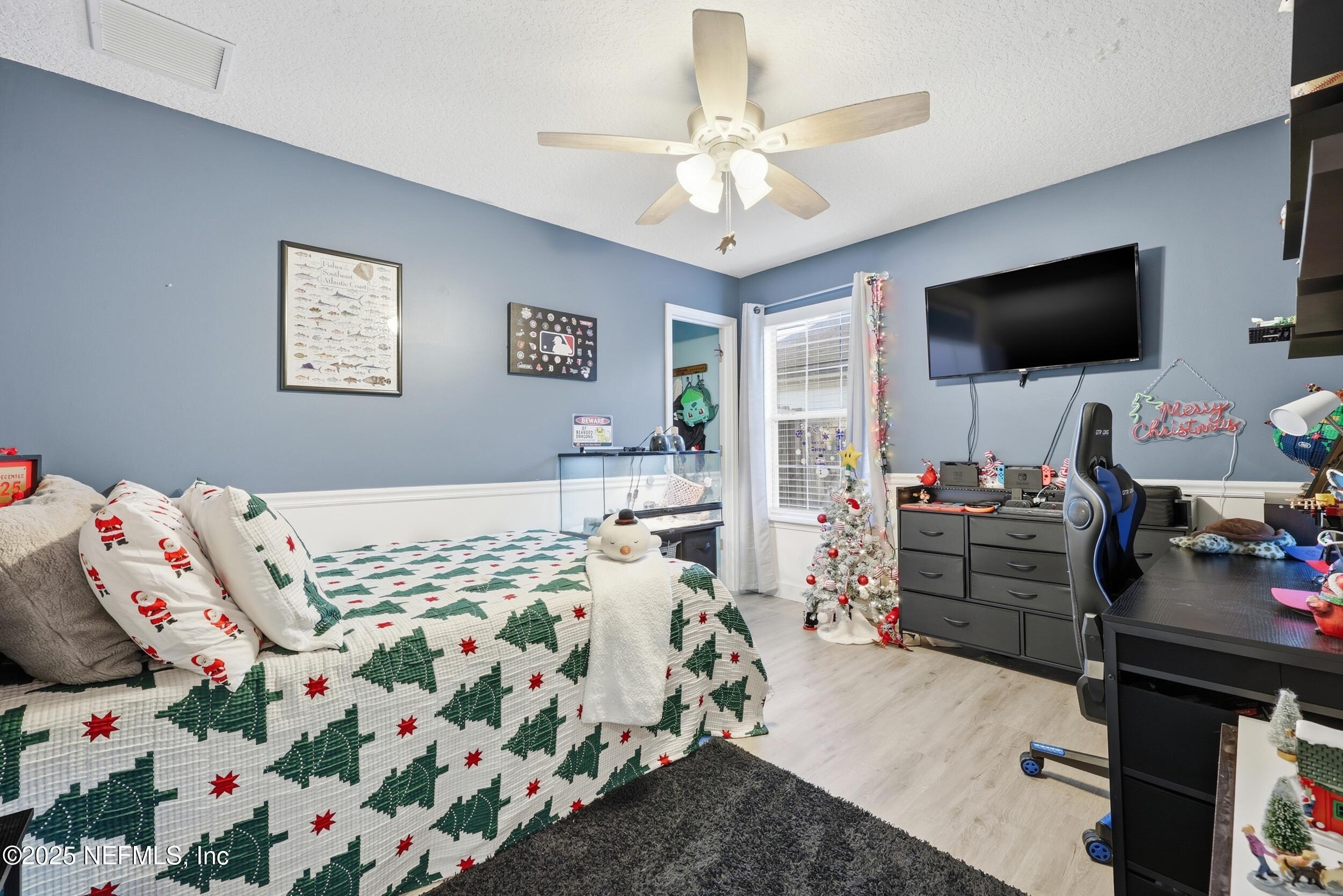 177 Summerhill Circle St. Augustine, FL 32086 - Photo 26 of 42 a bedroom with furniture and a flat screen tv