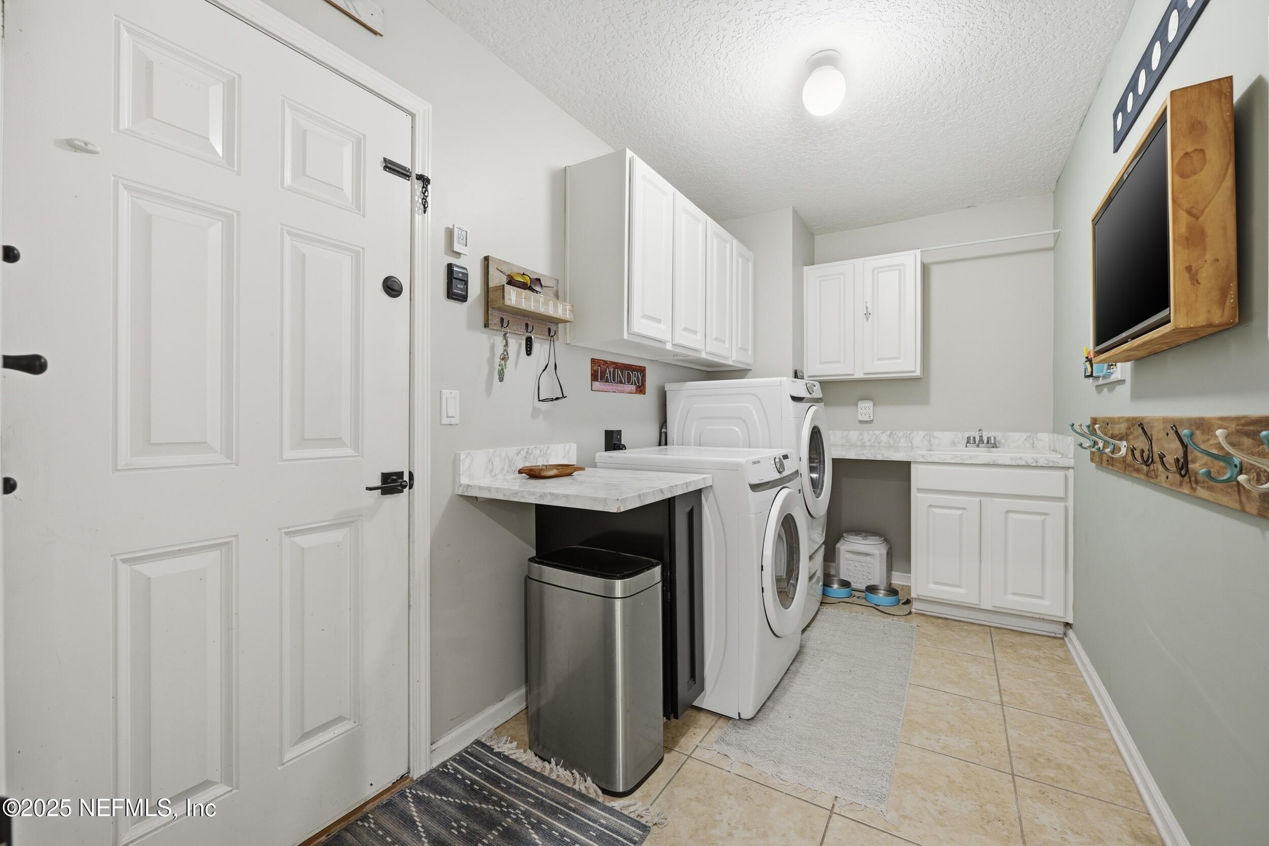 177 Summerhill Circle St. Augustine, FL 32086 - Photo 27 of 42 a kitchen with white cabinets and sink