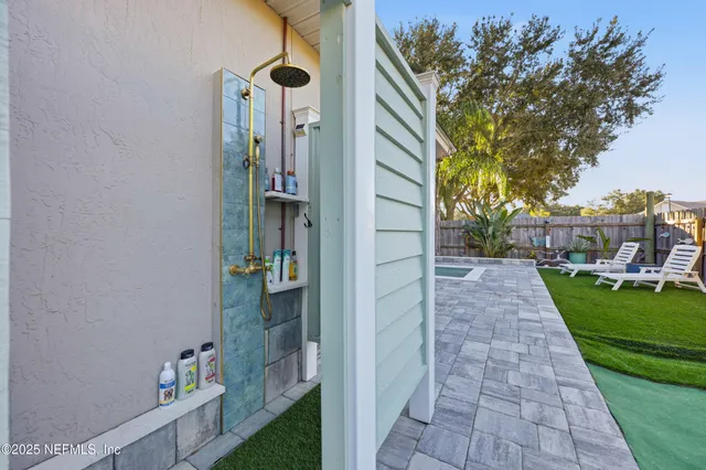 a view of a patio with a table and chairs and potted plants
