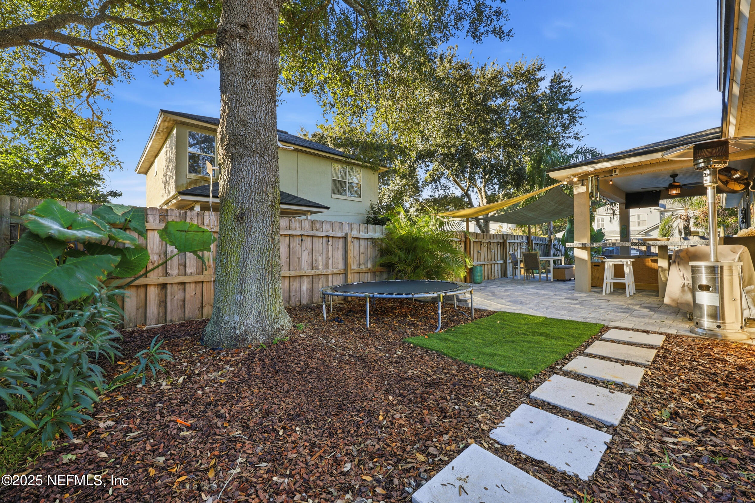 177 Summerhill Circle St. Augustine, FL 32086 - Photo 36 of 42 a view of a patio with a table and chairs and potted plants