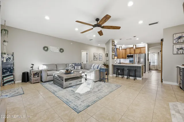 a living room with furniture and kitchen view