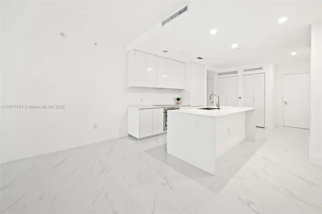 a kitchen with a sink stove and cabinets