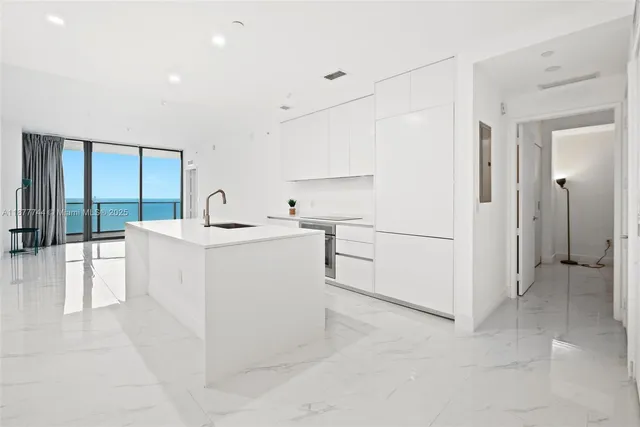 a view of a kitchen with white cabinets