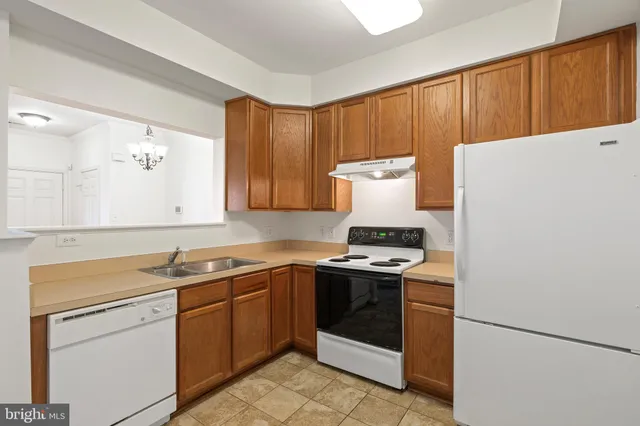 a kitchen with a stove sink and cabinets