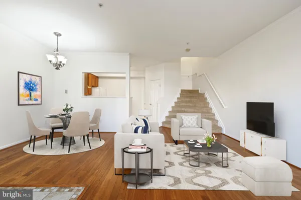 a living room with furniture a rug and a flat screen tv
