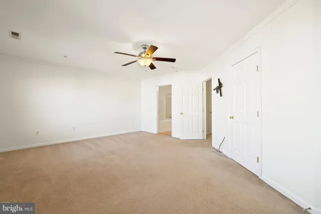 a view of a livingroom with a ceiling fan and window