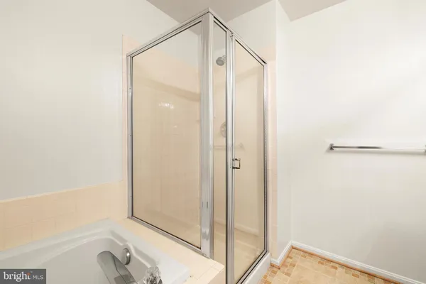 a bathroom with a shower and a bathtub