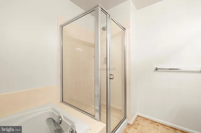 a bathroom with a shower and a bathtub