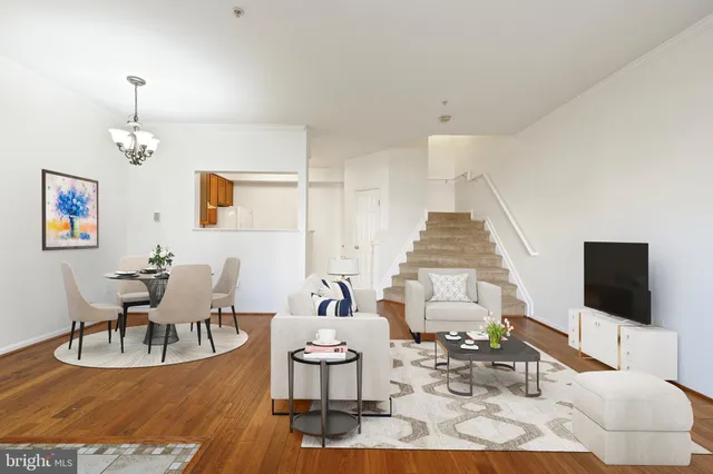 a living room with furniture a rug and a flat screen tv