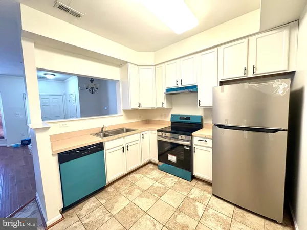 a kitchen with a refrigerator sink and stove