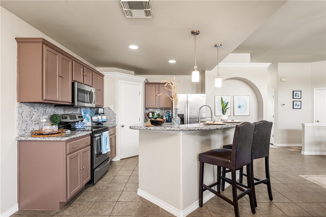 6630 Riding Wind Drive Corpus Christi, TX 78414 - Photo 11 of 40 a kitchen with a sink white cabinets and stainless steel appliances