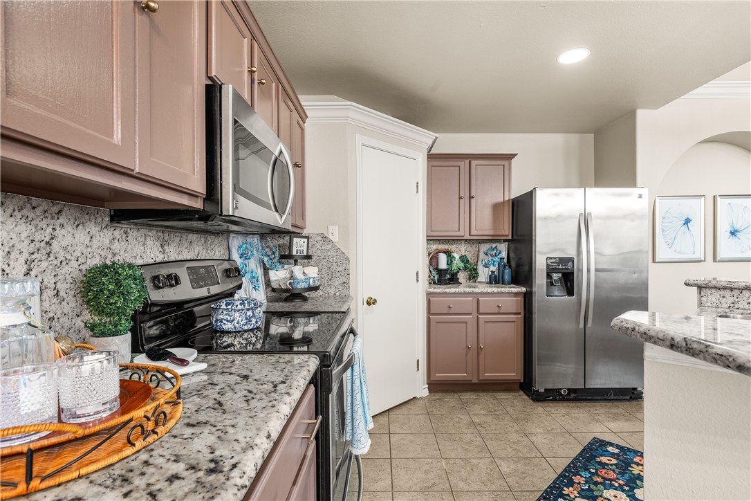 6630 Riding Wind Drive Corpus Christi, TX 78414 - Photo 14 of 40 a kitchen with stainless steel appliances granite countertop a refrigerator a stove and a sink