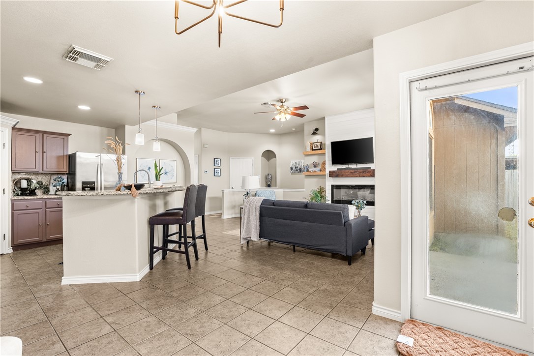 6630 Riding Wind Drive Corpus Christi, TX 78414 - Photo 16 of 40 a living room with furniture a flat screen tv and kitchen view