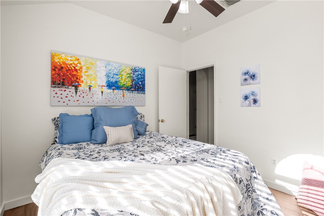 6630 Riding Wind Drive Corpus Christi, TX 78414 - Photo 20 of 40 a large bed sitting in a bedroom next to a painting on the wall