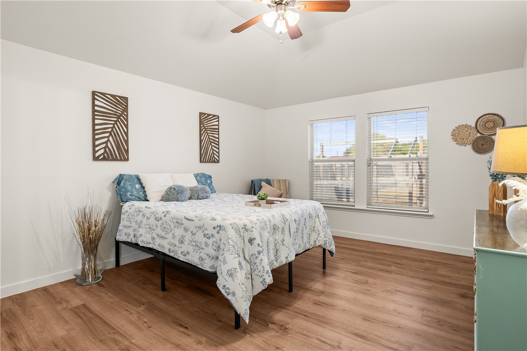 6630 Riding Wind Drive Corpus Christi, TX 78414 - Photo 26 of 40 a spacious bedroom with a bed and wooden floor