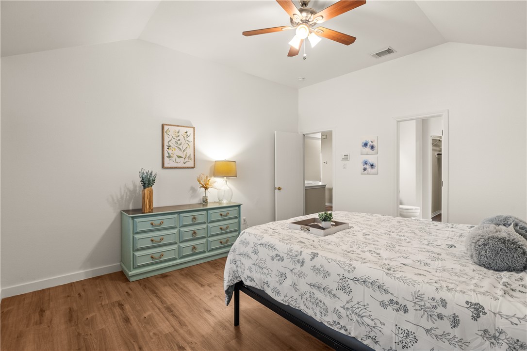 6630 Riding Wind Drive Corpus Christi, TX 78414 - Photo 27 of 40 a bedroom with a bed and a chandelier