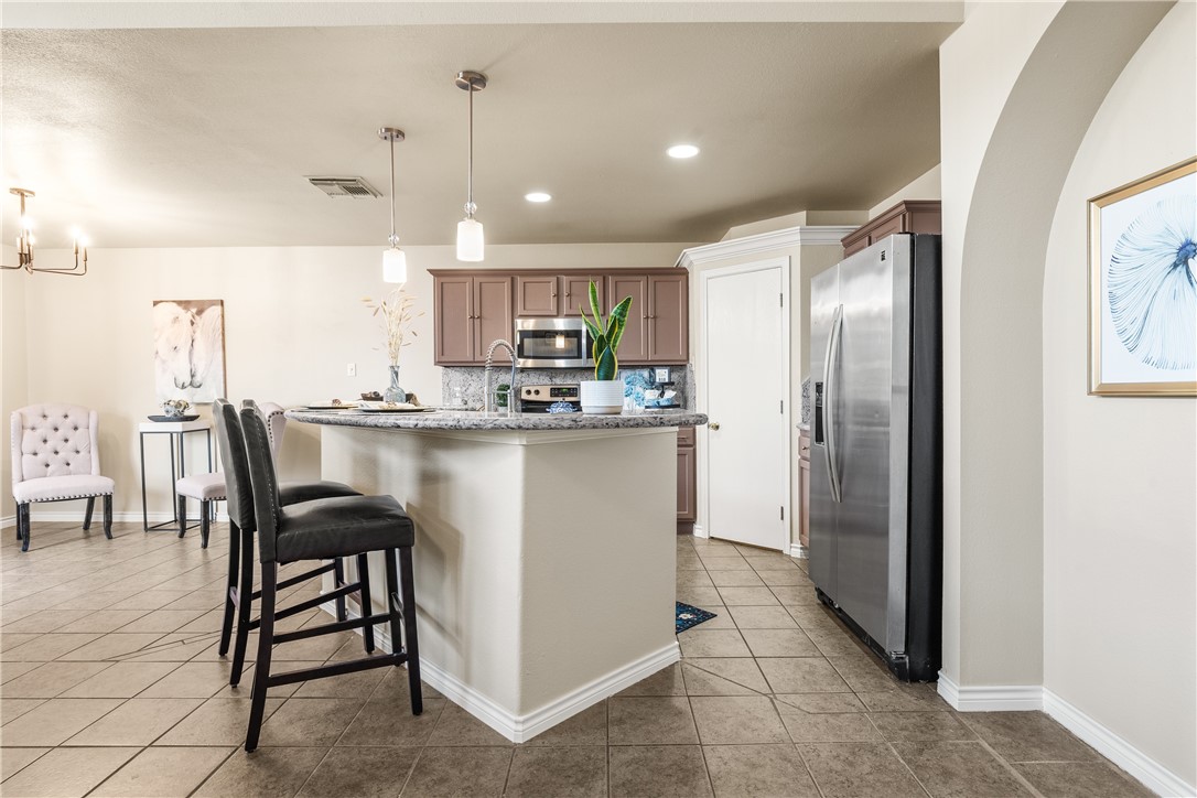 6630 Riding Wind Drive Corpus Christi, TX 78414 - Photo 10 of 40 a kitchen with kitchen island a counter top space a sink appliances and cabinets