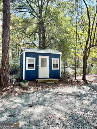 a view of yard with wooden fence