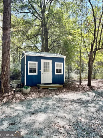 a view of yard with wooden fence