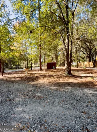 a front view of a house with a large tree
