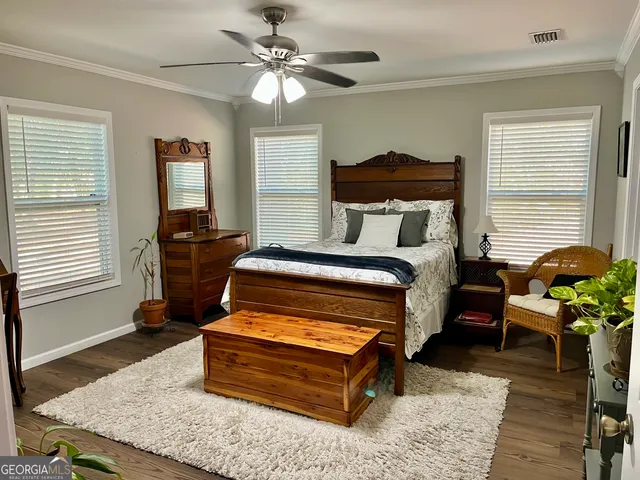 a bedroom with furniture and wooden floor