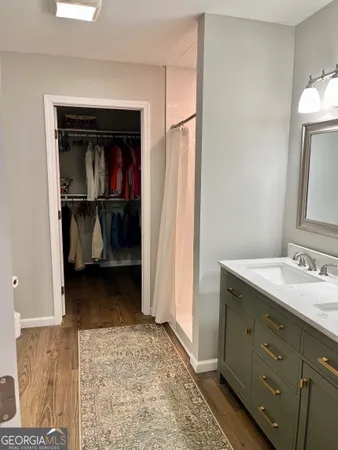 a bathroom with a sink vanity and mirror