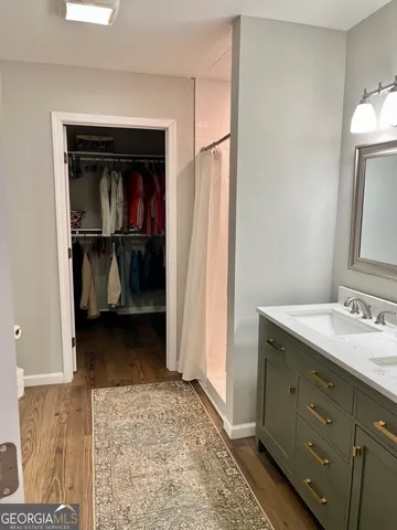 a bathroom with a sink vanity and mirror