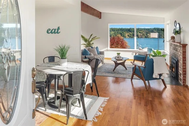 a living room with furniture a fireplace and a floor to ceiling window