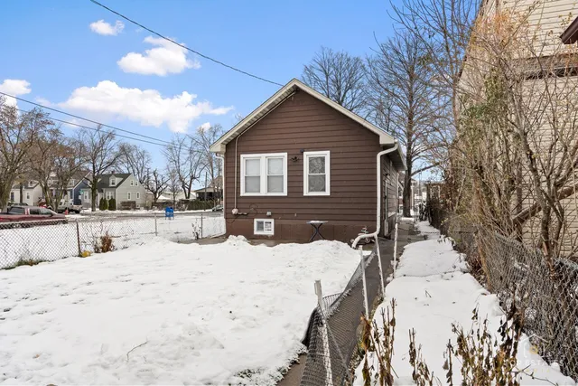 a view of a house with snow on the road