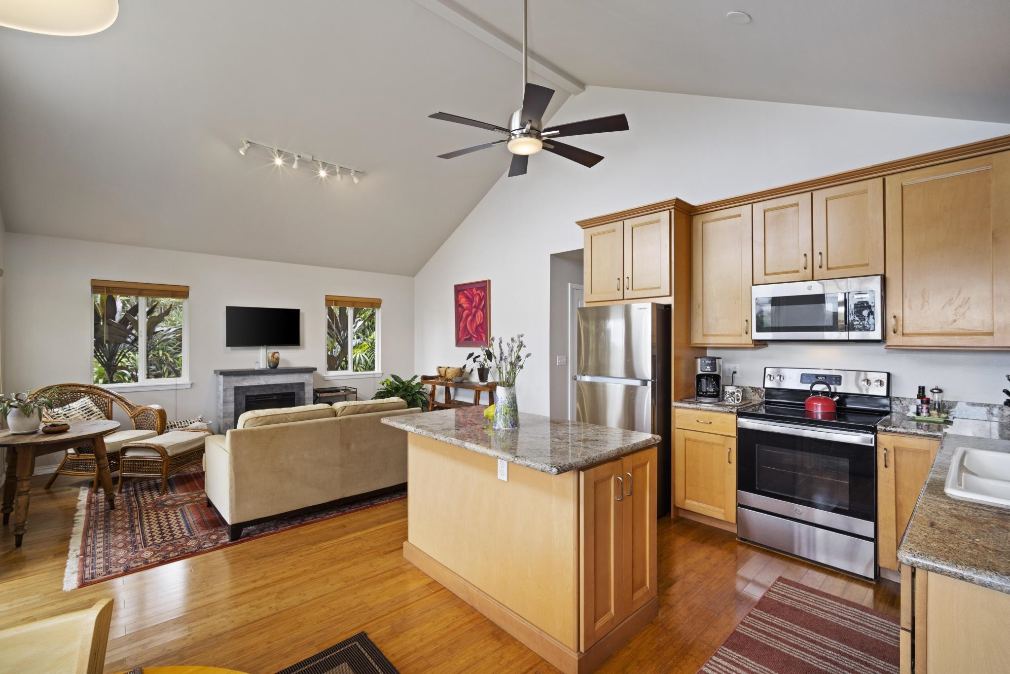 75 Ainakula Road, Unit A Kula, HI 96790 - Photo 12 of 45 a living room with stainless steel appliances furniture a flat screen tv and kitchen view