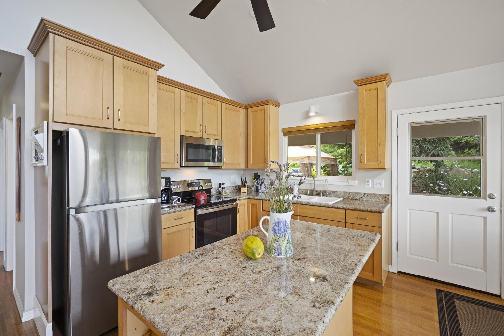 75 Ainakula Road, Unit A Kula, HI 96790 - Photo 14 of 45 a kitchen with stainless steel appliances granite countertop a refrigerator a stove top oven a sink and dishwasher