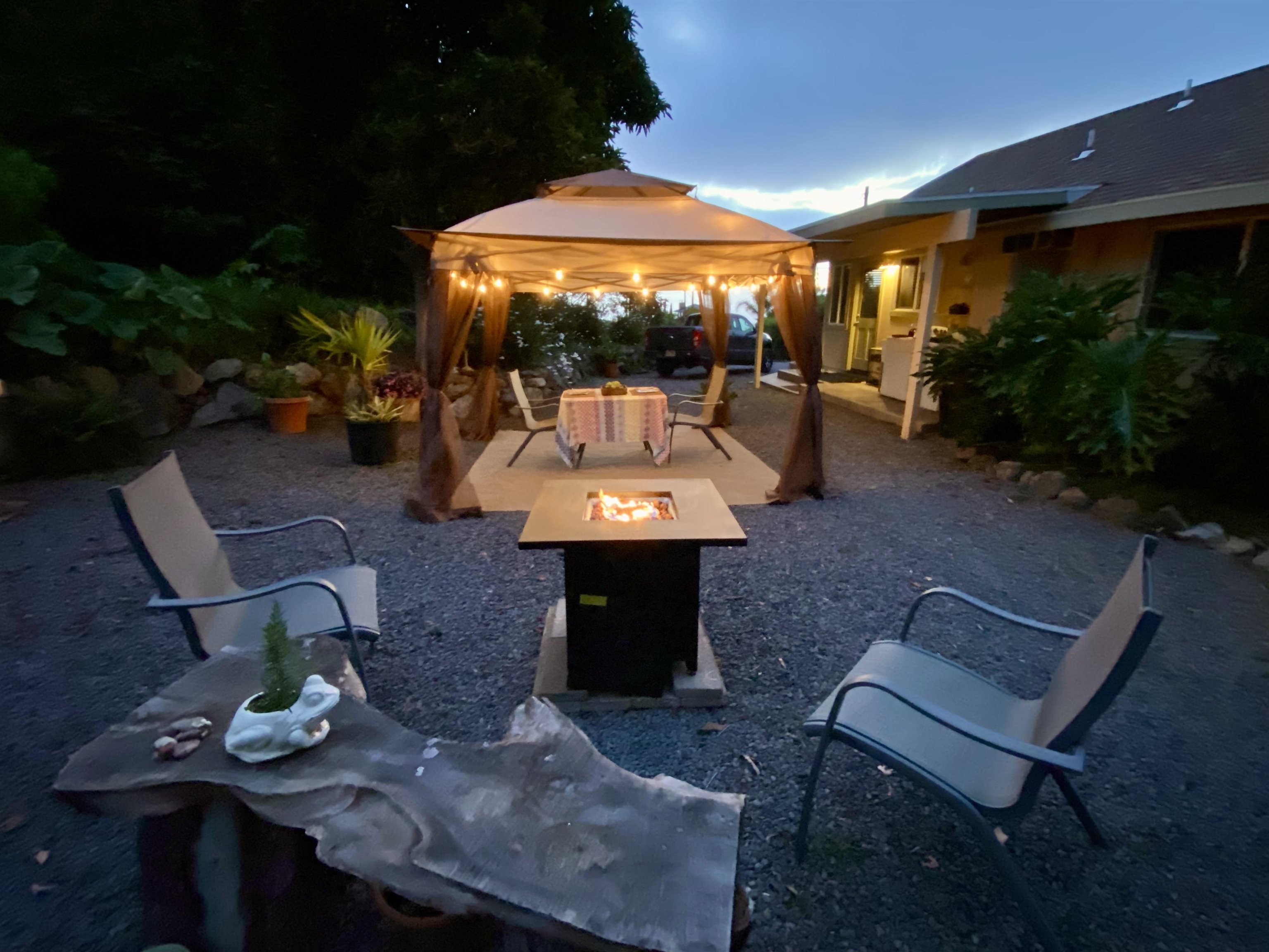 75 Ainakula Road, Unit A Kula, HI 96790 - Photo 43 of 45 a front view of a house with a yard glass top table and chairs