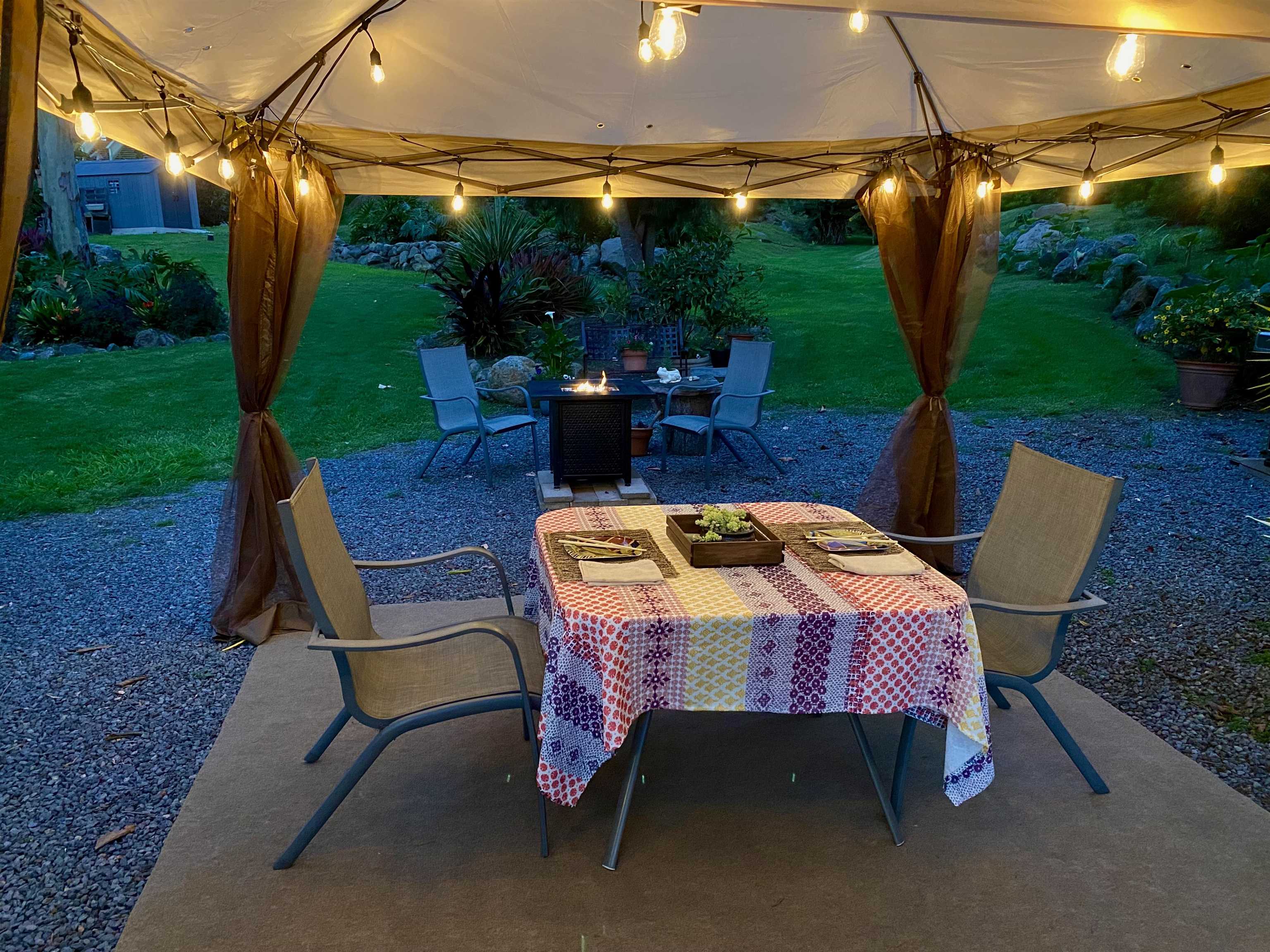 75 Ainakula Road, Unit A Kula, HI 96790 - Photo 6 of 45 a view of a patio with a table chairs and a backyard