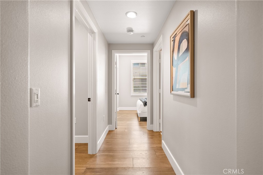 200 Rose Arch Irvine, CA 92620 - Photo 15 of 39 a view of a hallway with wooden floor and a bathroom