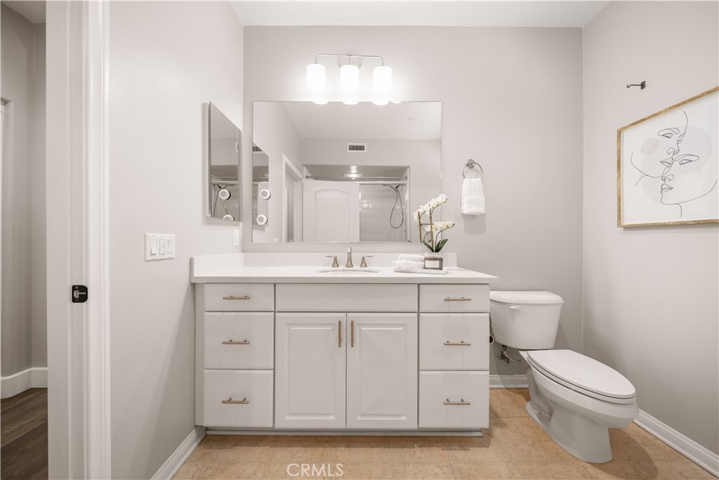 200 Rose Arch Irvine, CA 92620 - Photo 23 of 39 a bathroom with a toilet a sink and mirror