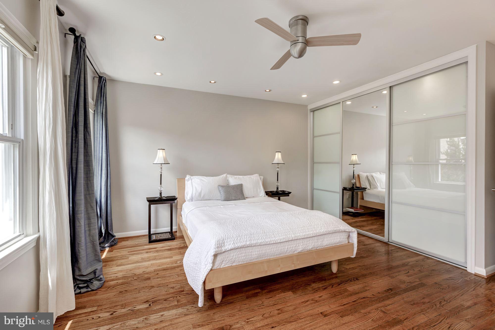 1910 17th Street Northwest Washington, DC 20009 - Photo 18 of 30 a bedroom with a large bed and a chandelier