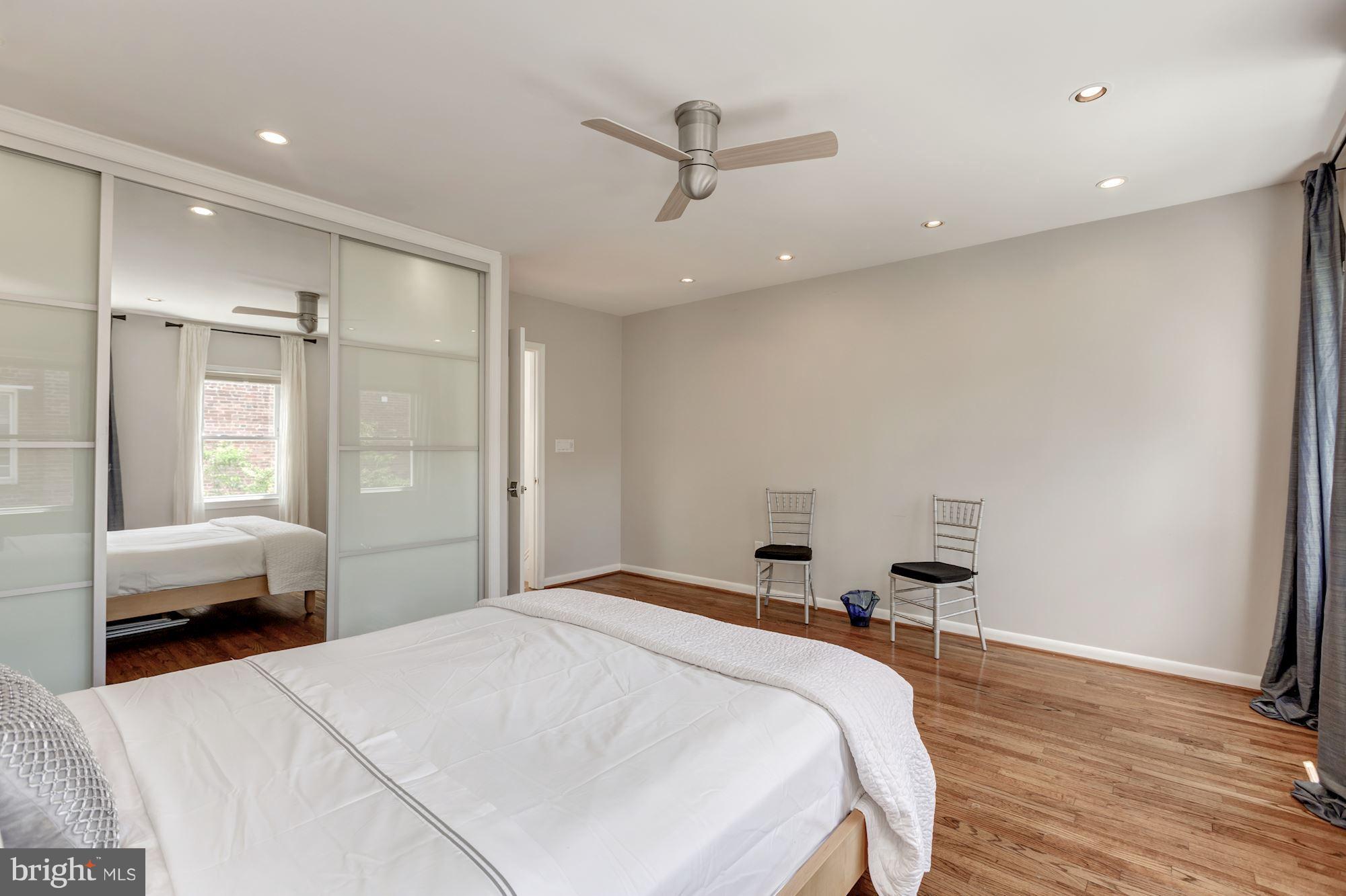 1910 17th Street Northwest Washington, DC 20009 - Photo 19 of 30 a spacious bedroom with a bed and a window