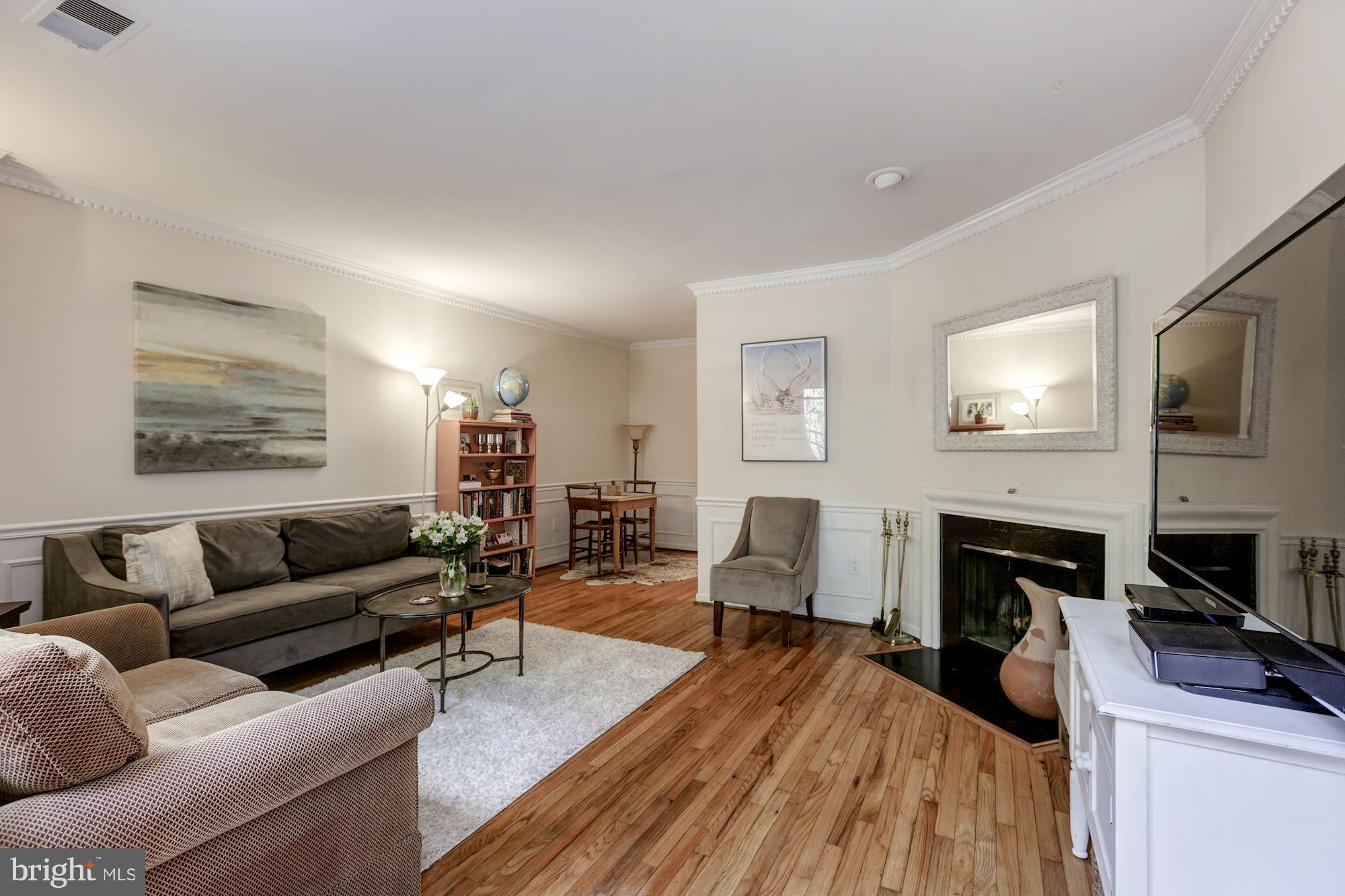 1910 17th Street Northwest Washington, DC 20009 - Photo 20 of 30 a living room with furniture a fireplace and a flat screen tv