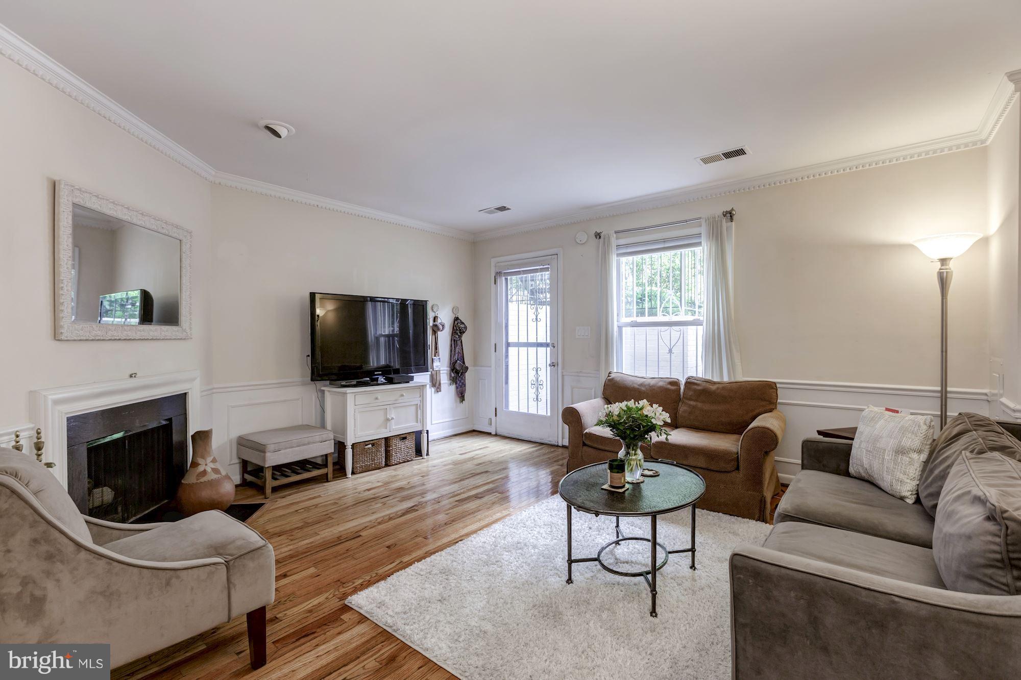 1910 17th Street Northwest Washington, DC 20009 - Photo 21 of 30 a living room with furniture and a flat screen tv