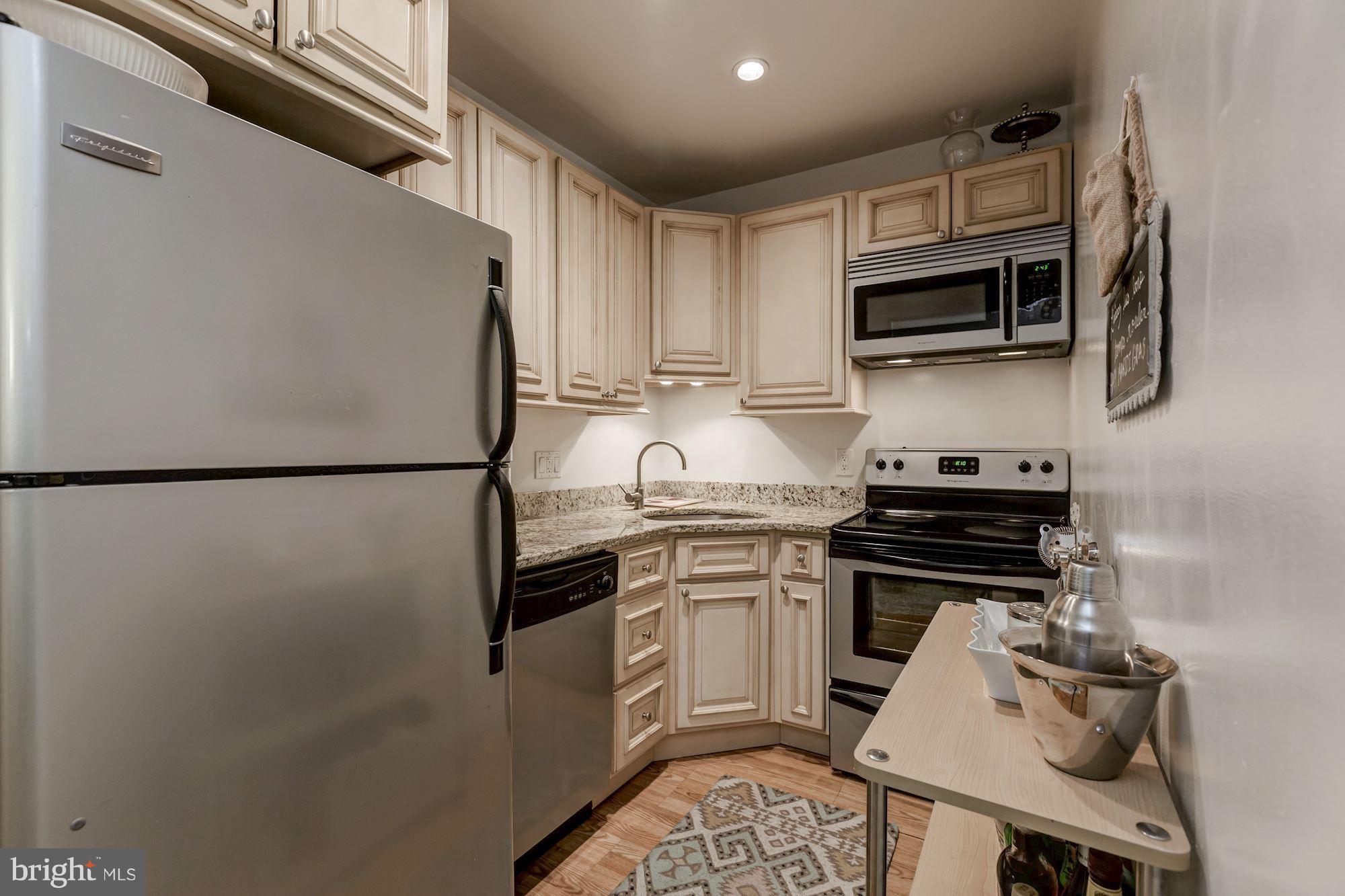 1910 17th Street Northwest Washington, DC 20009 - Photo 24 of 30 a kitchen with stainless steel appliances a sink stove and refrigerator