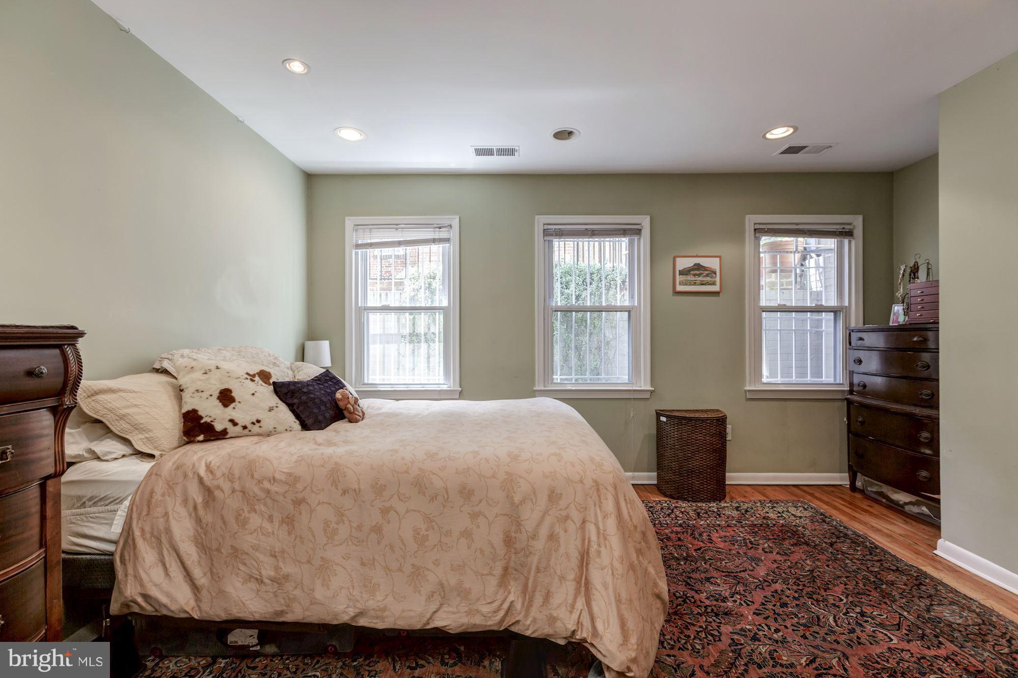 1910 17th Street Northwest Washington, DC 20009 - Photo 26 of 30 a bedroom with a bed and wooden floor