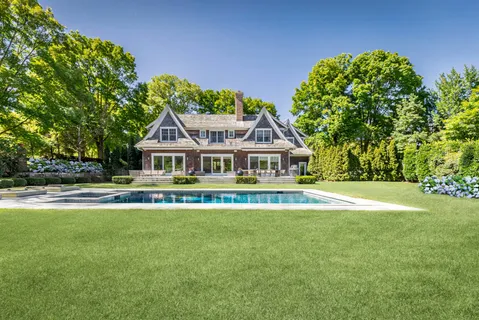a view of a house with swimming pool and sitting area