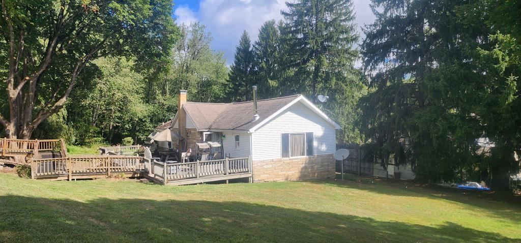a view of a house with a yard porch and sitting area