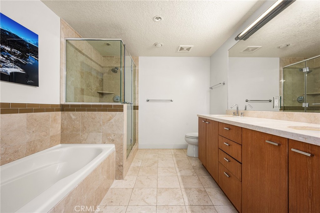 3131 Michelson Drive, Unit 606 Irvine, CA 92612 - Photo 13 of 32 a spacious bathroom with a tub sink shower and mirror