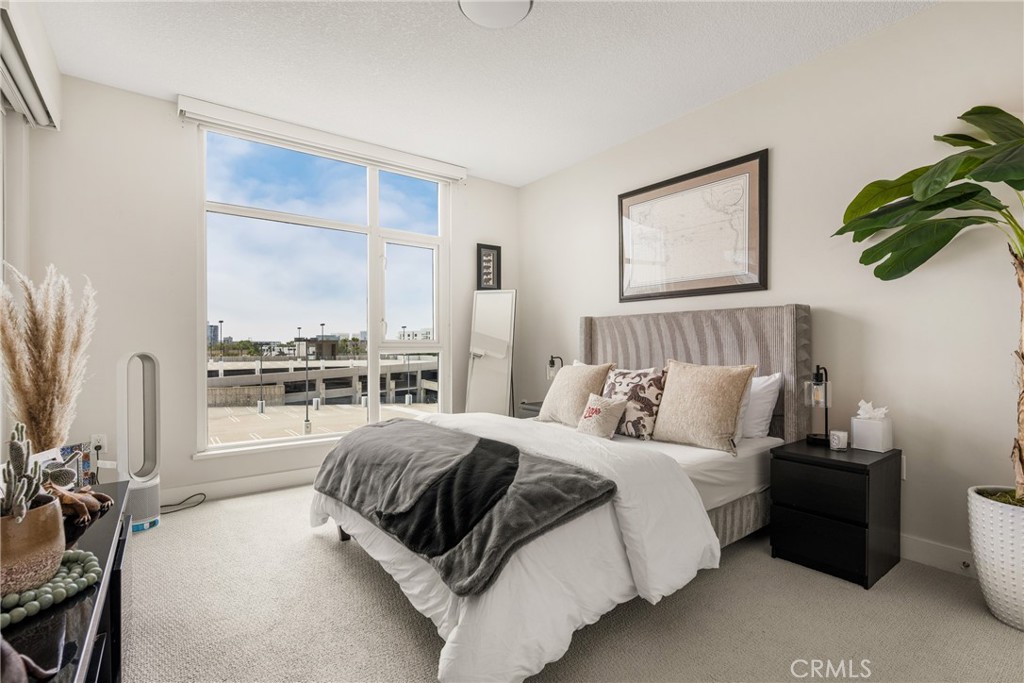 3131 Michelson Drive, Unit 606 Irvine, CA 92612 - Photo 16 of 32 a bedroom with a bed and a window