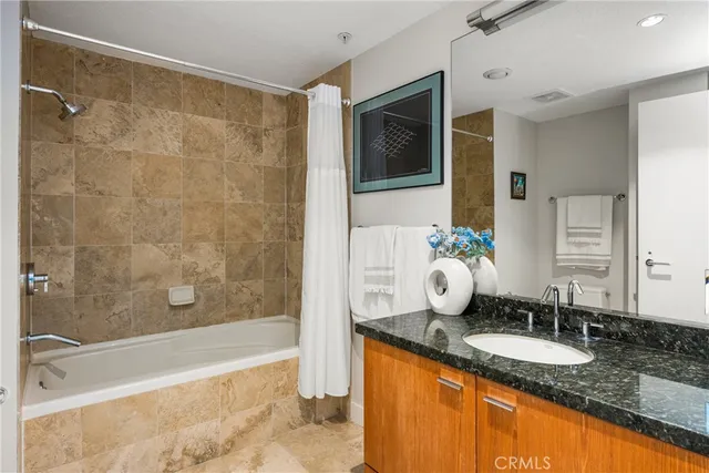 a bathroom with a shower and a painting on the wall