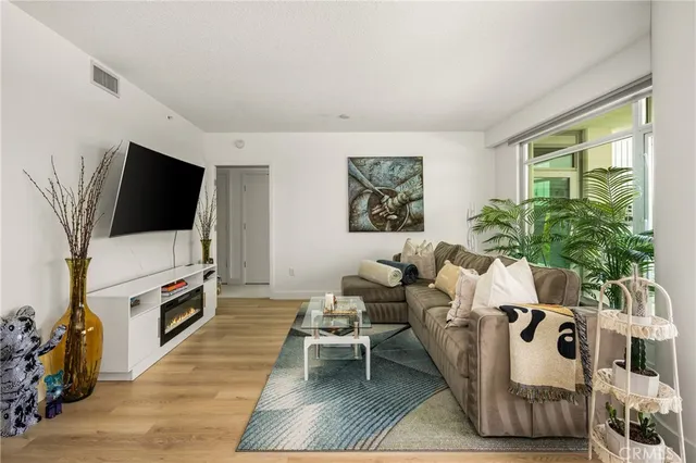 a view of a livingroom with furniture and floor to ceiling window