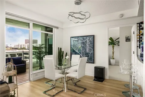 a living room with furniture and view of kitchen