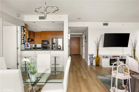 a kitchen with stainless steel appliances granite countertop a sink a stove and a refrigerator